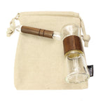 a small glass bottle with a wooden handle