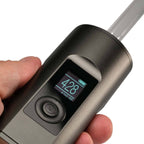a person is holding an electronic device with a clock on it